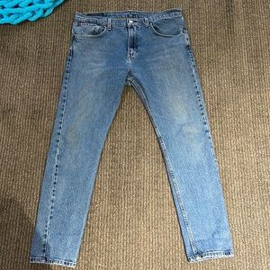 Levi’s, mid-rise, denim jeans. On hole by the back left pocket.